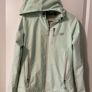 Size S Mint colored New Balance Raincoat. Great condition!